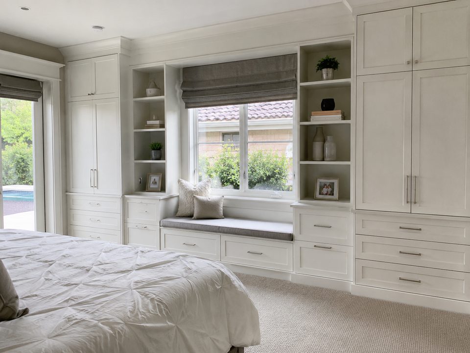 Bedroom built-in cabinets with a window seat, drawer banks, and tall wardrobes