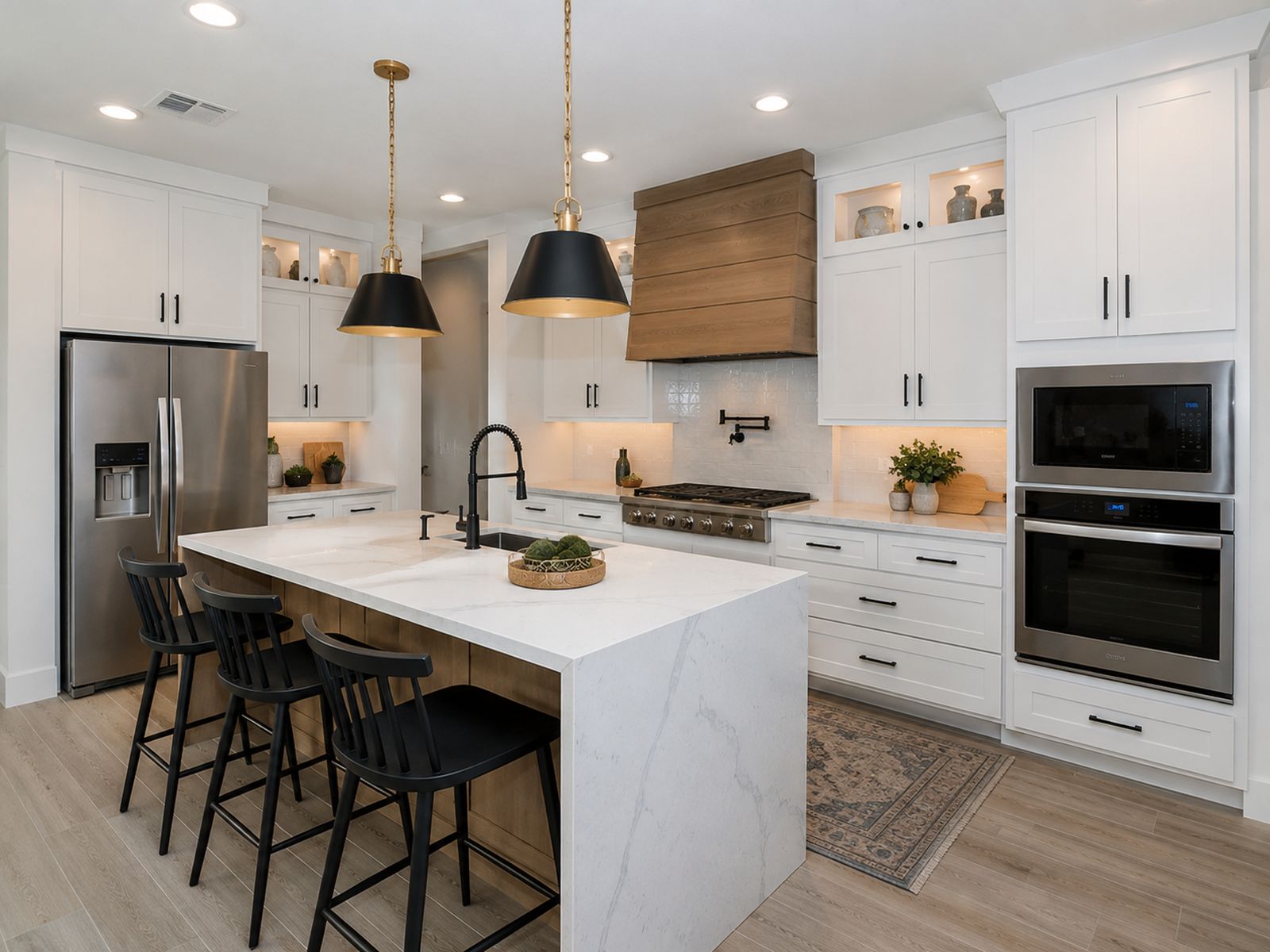 Custom kitchen cabinets built in Clovis, CA with white shaker doors and a quartz waterfall island